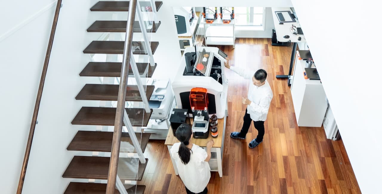 Inside the FramesCanvas print studio in Japan, with 3D printers running in a clean, well-organized production space.
